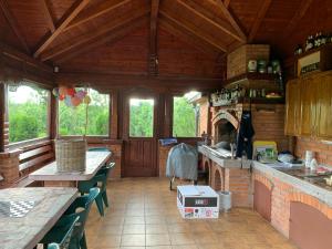 a kitchen with a brick oven in a cabin at Family resort TRAPISTI in Banja Luka