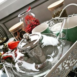 a shelf with a glass jar and dishes on it at Small Hill Heaven in Varaždin Breg