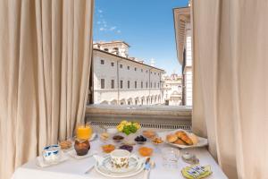 a breakfast table with a view of the city at NavonaMyHome in Rome
