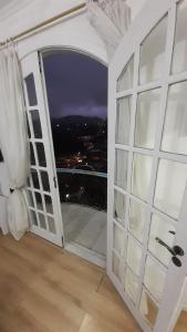 an open door to a balcony with a view at Solar Gema da Serra in Petrópolis