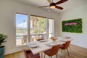 a dining room with a table with chairs and a ceiling fan at Luxury Palm Springs Retreat w/ Heated Pool & Spa in Palm Springs