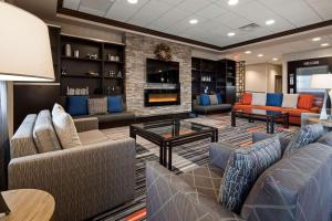 a lobby with couches and chairs and a fireplace at Best Western Plus Waterloo in Waterloo