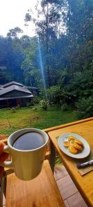 a cup of coffee and a plate of cookies on a table at Estancia del Monje in Cobán