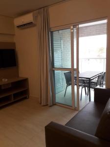 a living room with a sliding glass door to a patio at Salinas Park Resort in Salinópolis