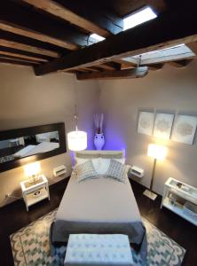 a bedroom with a bed and a mirror and lights at Dimora Arco Basso - Old Town in Bari