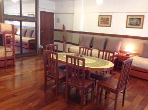 a room with a table and chairs and a bed at Apart Hotel Family in Mar del Plata