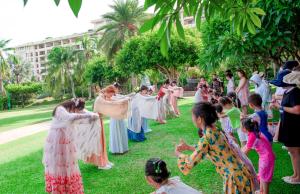a group of children dancing in front of a wedding party at Horizon Resort & Spa Yalong Bay-Yalong Bay Central in Sanya +186 photos