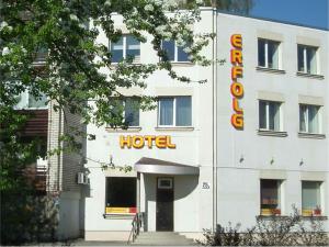 a building with a hotel sign on the side of it at Hotel Erfolg in Daugavpils