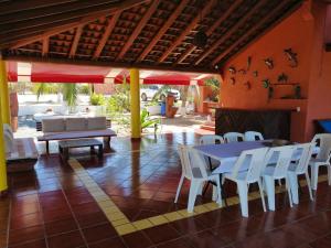 a patio with a table and chairs and a fireplace at Casa La Quinta Ola in Troncones