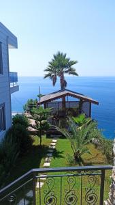a house with a gazebo on a hill with the ocean at Sunset villa in Alanya