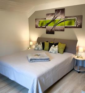 a bedroom with a bed with white sheets and pillows at Apartment Bergfeeling in Russbach am Pass Gschütt