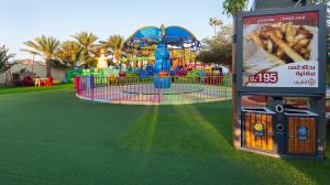 a park with a playground with a roller coaster at بيرحاء إبراء للسياحة in Ibrā
