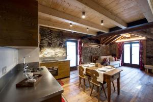 a kitchen with a table and a dining room at Le Relais du Boucher in Gaby