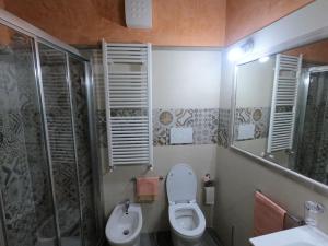 a bathroom with a toilet and a sink and a shower at Bed and Breakfast Dal Tenente in SantʼAngelo in Vado