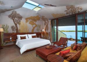 a bedroom with a bed and a living room at RAAS Chhatrasagar, Nimaj, District Pali in Pāli