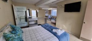 a bedroom with a bed and a television in a room at Ocean Parade Motel in Coffs Harbour