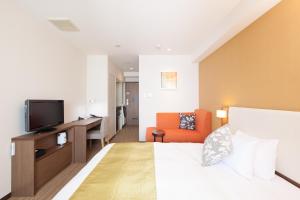a hotel room with a bed and a television at Tokyu Stay Yoga in Tokyo