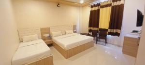 Ein Bett oder Betten in einem Zimmer der Unterkunft Sanjog Resort