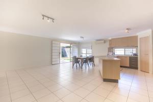 a large kitchen and dining room with a table and chairs at Immaculate House, Indulgent Living! in Brisbane