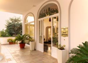 an arched entryway to a house with potted plants at Hotel Bellavista in Anacapri