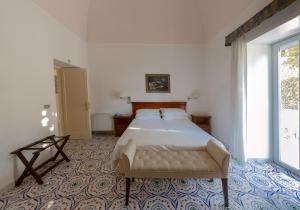 a bedroom with a bed and a large window at Hotel Bellavista in Anacapri