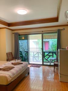 a bedroom with a bed and a large window at Koh Chang Hut Hotel in Ko Chang