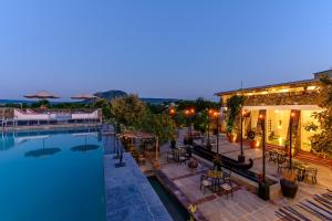 a hotel with a swimming pool at night at Utsav Camp Sariska in Tehla
