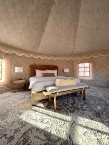 a bedroom with a bed and a table at Liwa Nights ليالي ليوا in Liwa