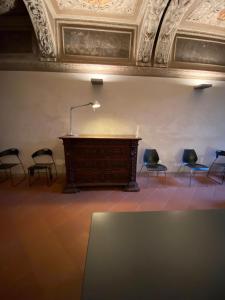 a podium in a room with chairs and a ceiling at Intero Appartamento. San Giovanni Uno in Brescia