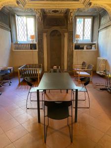 a room with a table and chairs in a building at Intero Appartamento. San Giovanni Uno in Brescia