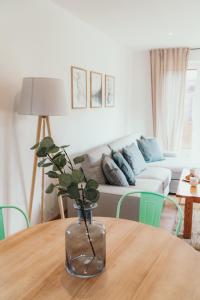 a living room with a table with a vase on it at Lake Park Łagów in Łagów