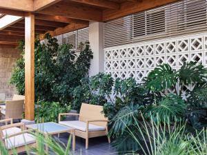 a patio with chairs and tables and plants at Esperia City Hotel in Rhodes Town