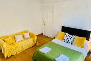 a living room with a couch and a bed at Balham, South London Spacious Guest House 1 in London