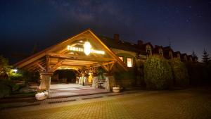 a house with a wooden roof at night at Navaria Nova in Lviv