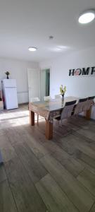 a large room with a wooden table and chairs at Elena Haus in Cluj-Napoca