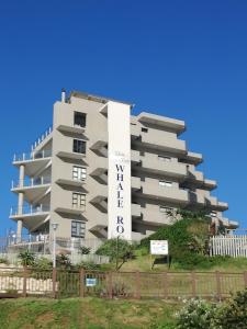 a tall apartment building with a sign on it at Whale Rock 22 Margate South Coast in Margate