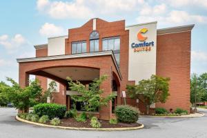 a building with a sign on the side of it at Comfort Suites Near Potomac Mills in Woodbridge