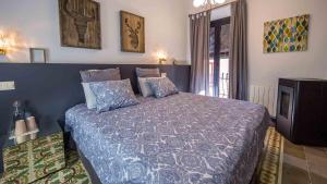 a bedroom with a bed and a television in it at Groc Rooms in La Seu d'Urgell