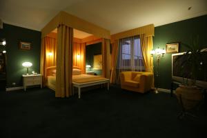 a bedroom with a canopy bed and a chair at Navaria Nova in Lviv +65 photos