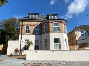 a large brick building with two windows on top at Beautifully Furnished 1 Bed Town Centre Apartment in Bournemouth