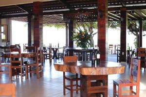 a restaurant with tables and chairs and a room with windows at Hotel e Mirante recanto alto da serra in Portalegre