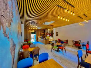 a restaurant with tables and chairs and a map on the wall at Victorious Hotel in Istanbul