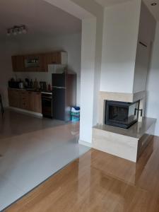 a kitchen with a fireplace in the middle of a room at Apartman Corluka Grude in Grude