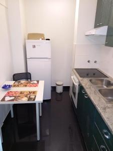 a small kitchen with a table and a sink at Apartman Bruna in Zagreb