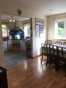 a kitchen and dining room with a table and chairs at Achmore Self catering in Achmore