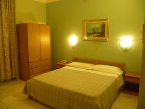 a bedroom with a bed and a picture on the wall at Hotel Pensione Romeo in Bari