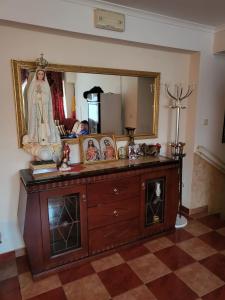 a room with a wooden dresser with a mirror at Hotel Matal in Međugorje