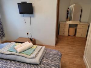 a bedroom with a bed with a tv on the wall at Hotel Matal in Međugorje