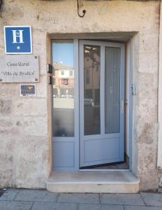 a door to a building with a sign on it at HOSTAL Villa de Brulles in Villadiego