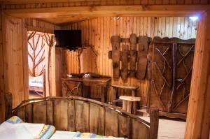 a room with a wooden wall with a bed in it at Pensiunea Sarmis in Sarmizegetusa